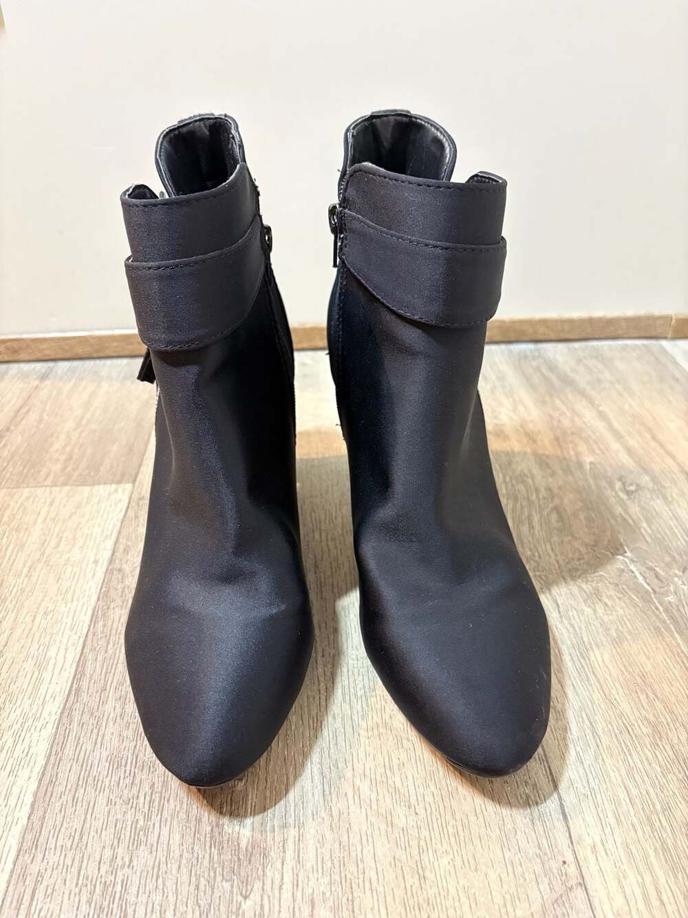 Black textile ankle boot  with a decorative buckle strap around the ankle.